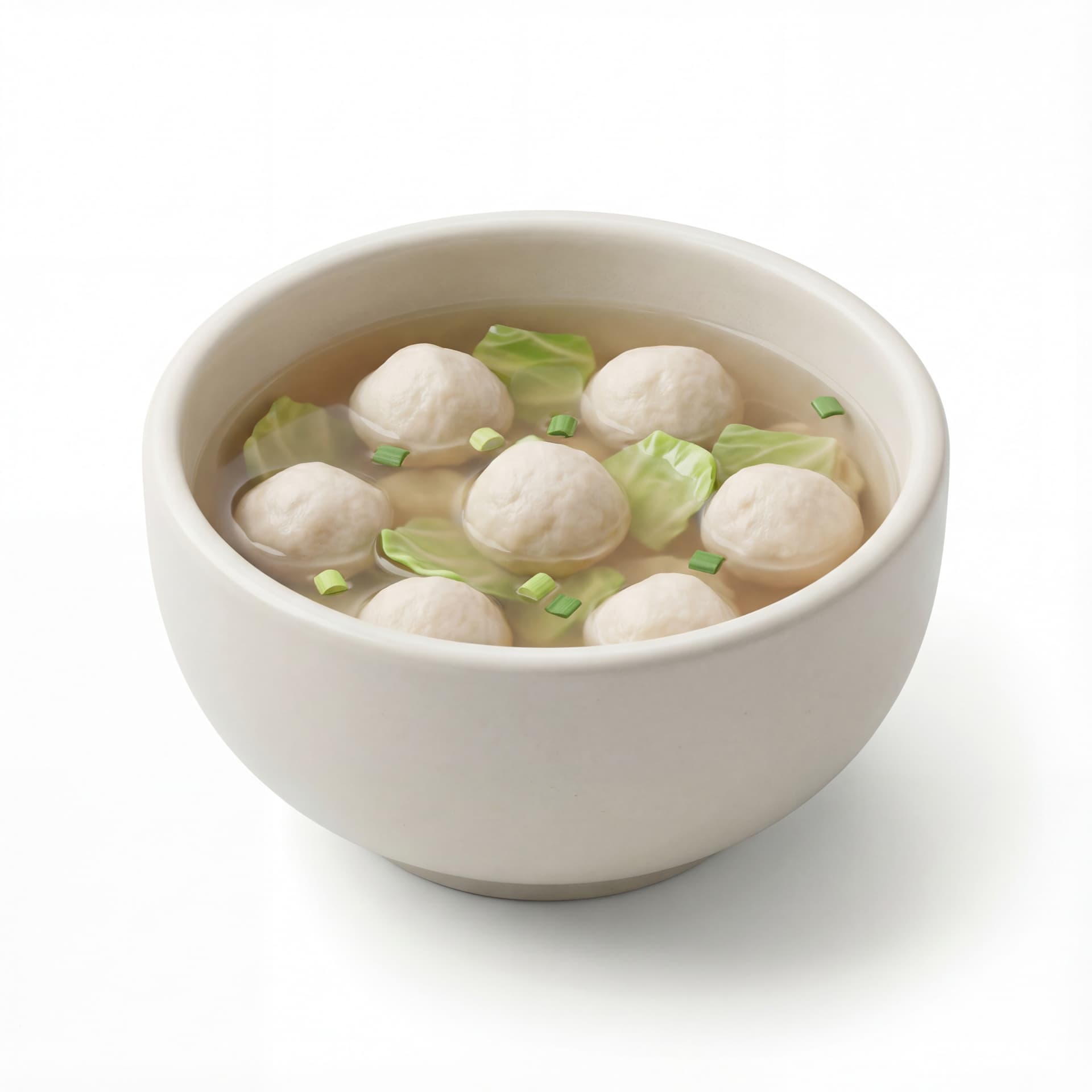 A soup bowl filled with fish ball soup including round fish balls, cabbage pieces, and clear broth.