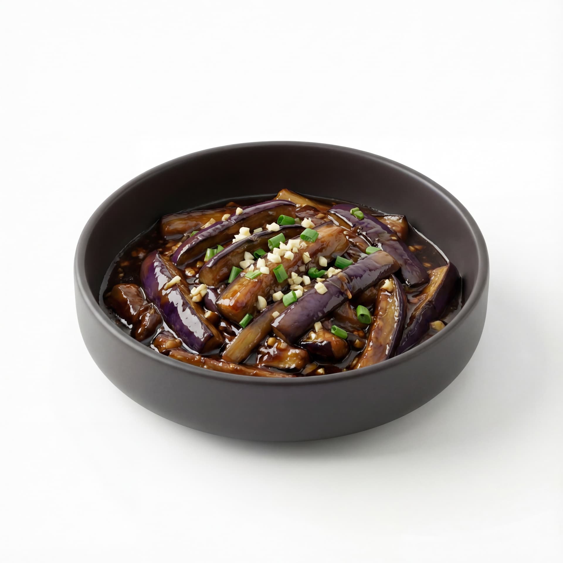 A dark shallow bowl containing braised eggplant with eggplant strips, minced garlic, green onion pieces, and thick soy-based sauce.