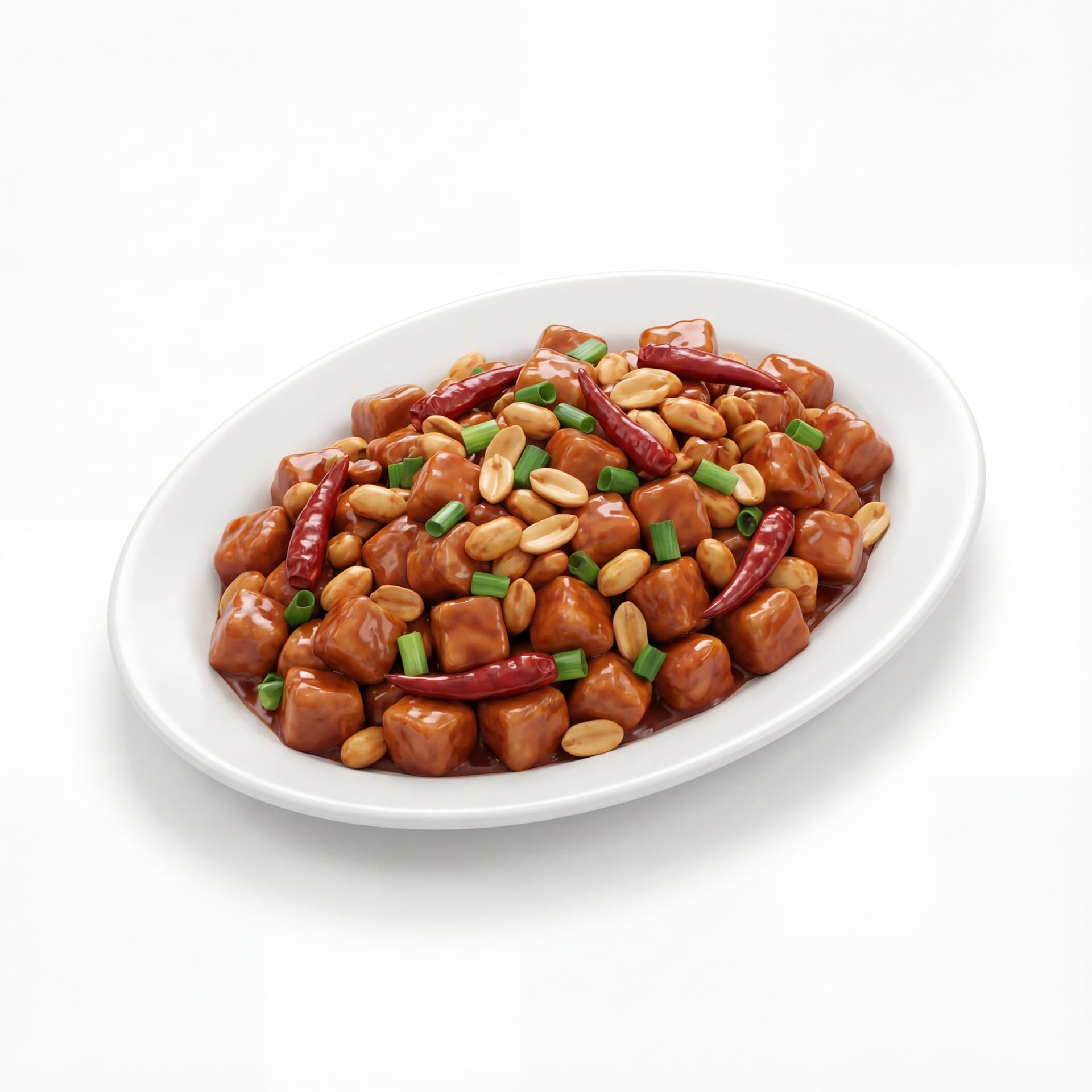 A oval plate holding Kung Pao chicken with diced chicken cubes, roasted peanuts, dried red chilies, and glossy brown-red sauce.